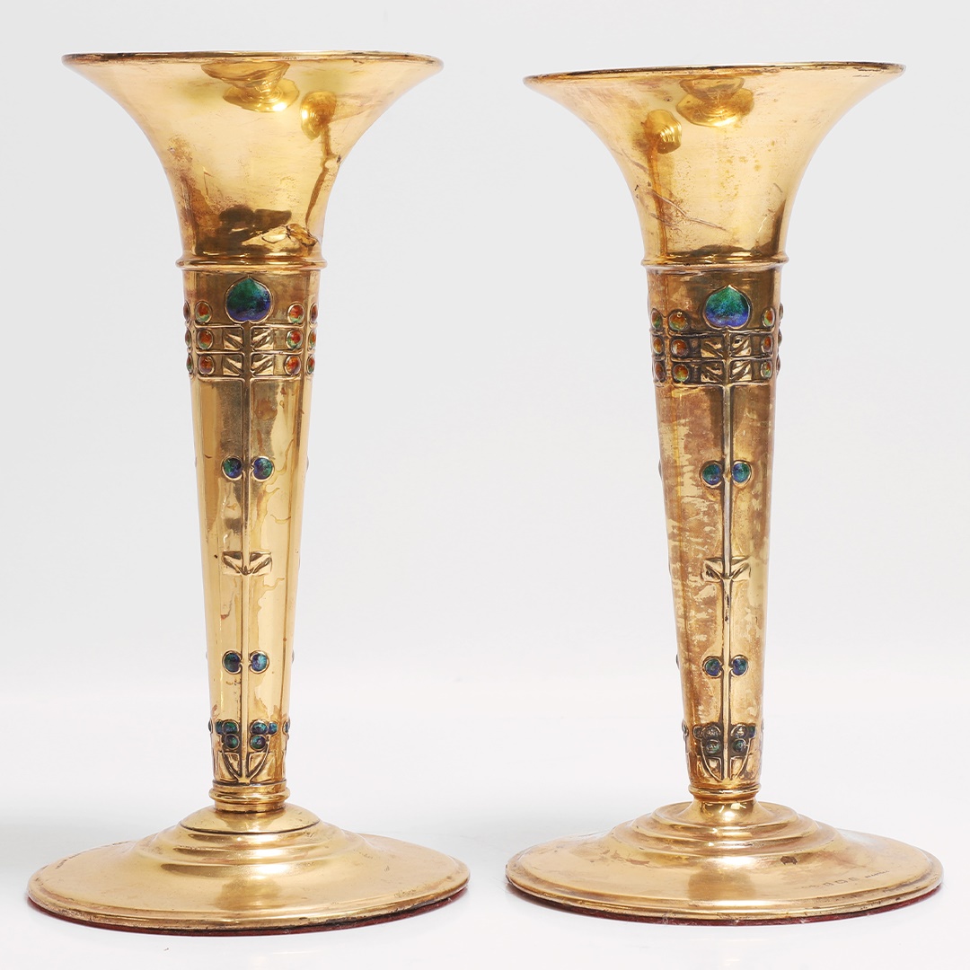 Archibald Knox (1864-1933) for Liberty & Co., a pair of 'Cymric' silver and enamel vases (£1,000-2,000)